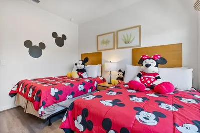 two beds with stuffed animals on them in a bedroom at Comfortable 3BdrmsPrivate Hot TubClose to Disney in Kissimmee