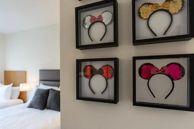 a wall with four framed pictures of hearts at Comfortable 3BdrmsPrivate Hot TubClose to Disney in Kissimmee