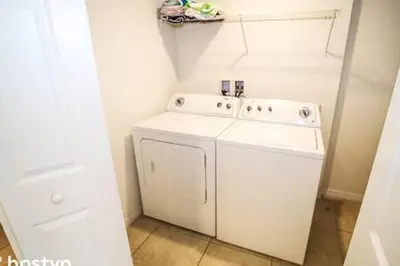 a white washer and dryer in a small room at Beautiful Townhome w Hot Tub Near Disney in Kissimmee