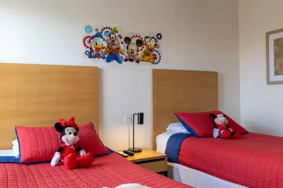 two beds with stuffed animals sitting on them in a bedroom at Amazing Townhouse for 6 people near Disney in Kissimmee