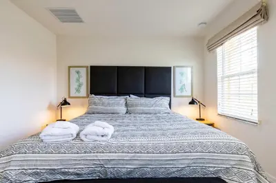 a bedroom with a large bed with two towels on it at Amazing Townhouse for 6 people near Disney in Kissimmee
