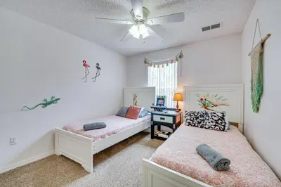a bedroom with two beds and a ceiling fan at 4 Mi to Disney Emerald Island Resort Home! in Kissimmee