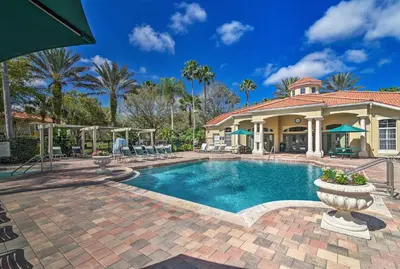 a house with a swimming pool in front of a house at 4 Mi to Disney Emerald Island Resort Home! in Kissimmee