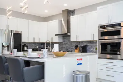 a kitchen with white cabinets and a white counter top at Last Minute Disney Getaway! Private Pool, Hot Tub & Games Room. Book Now! #60493 in Kissimmee