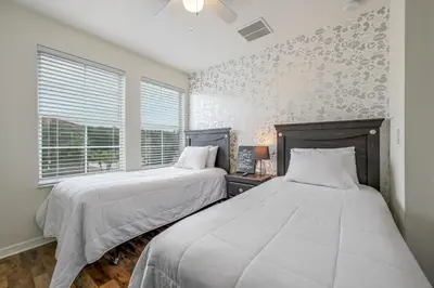 a bedroom with two beds and a window at Top Villas - Bella Vida Resort 203 in Kissimmee