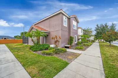 a pink house with a sidewalk in front of it at Top Villas - Bella Vida Resort 203 in Kissimmee