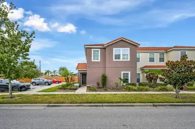 a house with cars parked in a parking lot at Top Villas - Bella Vida Resort 203 in Kissimmee