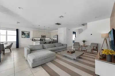 a living room with a couch and a table at Last Minute Disney Private Pool Hot Tub Game Room Themed Bedrooms. Book Now 43123 in Kissimmee