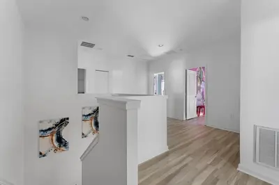 a living room with white walls and wooden floors at Last Minute Disney Private Pool Hot Tub Game Room Themed Bedrooms. Book Now 43123 in Kissimmee