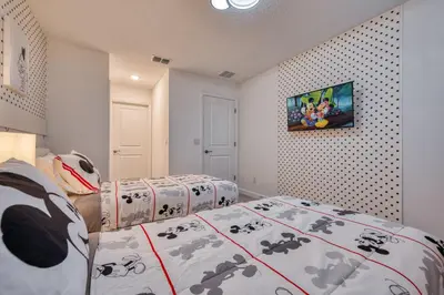 a bedroom with two beds and a painting on the wall at Last Minute Disney Getaway Private Pool Themed Bedrooms. Book Now 81937 in Orlando