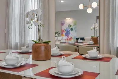 a dining room with a table with dishes and a vase with flowers at Last Minute Disney Getaway Private Pool Themed Bedrooms. Book Now 81931 in Orlando