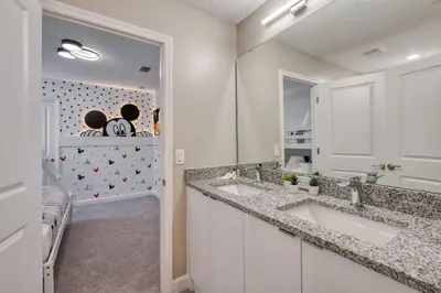a bathroom with two sinks and a mirror at Last Minute Disney Getaway Private Pool Themed Bedrooms. Book Now 81931 in Orlando