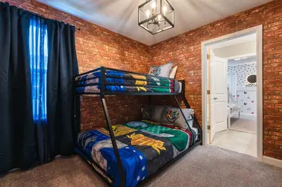 a bedroom with two bunk beds in a brick wall at Last Minute Disney Getaway Private Pool Themed Bedrooms. Book Now 81929 in Orlando
