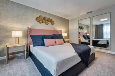 a bedroom with a large bed and a mirror at Last Minute Disney Getaway Private Pool Themed Bedrooms. Book Now 81925 in Orlando