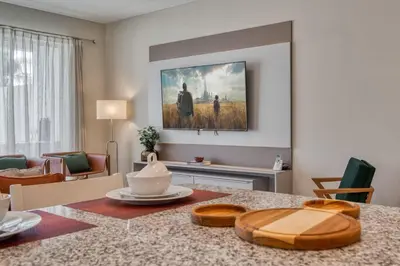 a living room with a dining room table with a painting on the wall at Last Minute Disney Getaway Private Pool Themed Bedrooms. Book Now 81921 in Orlando