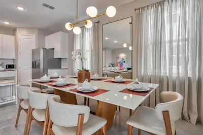 a dining room with a white table and chairs at Last Minute Disney Getaway Private Pool Themed Bedrooms. Book Now 81921 in Orlando