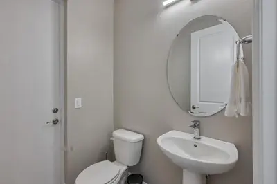 a bathroom with a toilet and a sink and a mirror at Last Minute Disney Getaway Private Pool Themed Bedrooms. Book Now 81921 in Orlando