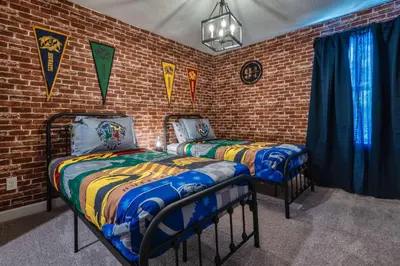 two beds in a room with a brick wall at Last Minute Disney Getaway Private Pool Themed Bedrooms. Book Now 81917 in Orlando