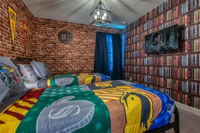 a bedroom with two beds and a brick wall at Last Minute Disney Getaway Private Pool Themed Bedrooms. Book Now 81917 in Orlando
