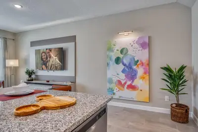 a kitchen with a counter and a painting on the wall at Last Minute Disney Getaway Private Pool Themed Bedrooms. Book Now 81911 in Orlando