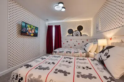 a bedroom with two beds and a wall with polka dots at Last Minute Disney Getaway Private Pool Themed Bedrooms. Book Now 81911 in Orlando