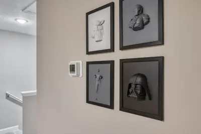 a group of framed pictures on a wall at Last Minute Disney Getaway Private Pool Themed Bedrooms. Book Now 81913 in Orlando