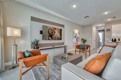 a living room with a couch and a tv at Last Minute Disney Getaway Private Pool Themed Bedrooms. Book Now 81913 in Orlando