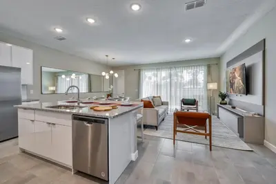 a kitchen with a sink and a living room at Last Minute Disney Getaway Private Pool Themed Bedrooms. Book Now 81909 in Orlando
