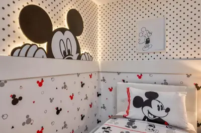 a bedroom with a bed with mickey mouse wallpaper at Last Minute Disney Getaway Private Pool Themed Bedrooms. Book Now 81909 in Orlando