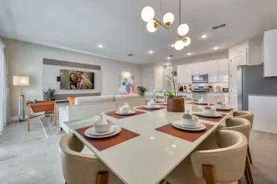 a dining room and living room with a table and chairs at Last Minute Disney Getaway Private Pool Themed Bedrooms. Book Now 81901 in Orlando