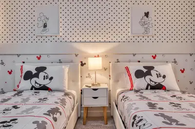 two twin beds in a bedroom with hello kitty wallpaper at Last Minute Disney Getaway Private Pool Themed Bedrooms. Book Now 81951 in Orlando