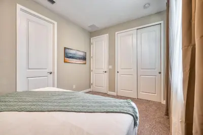 a bedroom with two white doors and a bed at Last Minute Disney Getaway Private Pool Themed Bedrooms. Book Now 81947 in Orlando