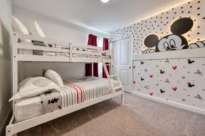 a childs bedroom with a bunk bed with mickey mouse wallpaper at Last Minute Disney Getaway Private Pool Themed Bedrooms. Book Now 91347 in Orlando