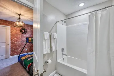 a bathroom with a brick wall and a shower at Last Minute Disney Getaway Private Pool Themed Bedrooms. Book Now 91347 in Orlando