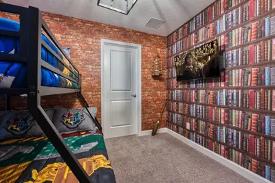 a bedroom with a wall of dvds at Last Minute Disney Getaway Private Pool Themed Bedrooms. Book Now 91347 in Orlando
