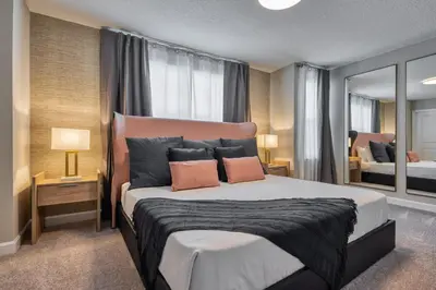 a bedroom with a large bed with two pillows at Last Minute Disney Getaway Private Pool Themed Bedrooms. Book Now 95041 in Orlando