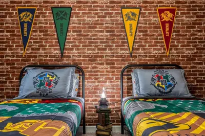 two beds in a room with kites on a brick wall at Last Minute Disney Getaway Private Pool Themed Bedrooms. Book Now 81943 in Orlando