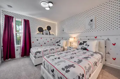 two beds in a bedroom with red curtains at Last Minute Disney Getaway Private Pool Themed Bedrooms. Book Now 81943 in Orlando