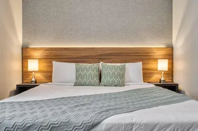 a bedroom with a large white bed with two lamps at Last Minute Disney Getaway Private Pool Themed Bedrooms. Book Now 81941 in Orlando