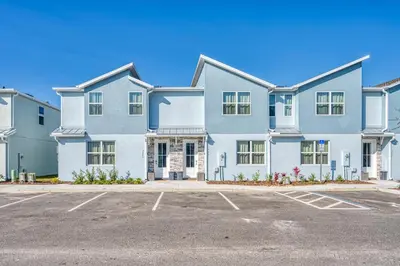a large white house with a parking lot at Last Minute Disney Getaway Private Pool Themed Bedrooms. Book Now 81941 in Orlando