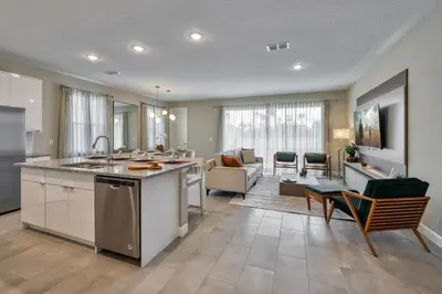 an open kitchen and living room with a couch at Last Minute Disney Getaway Private Pool Themed Bedrooms. Book Now 92789 in Orlando