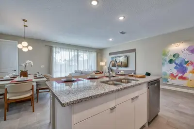 a kitchen with a sink and a dining room at Last Minute Disney Getaway Private Pool Themed Bedrooms. Book Now 92789 in Orlando