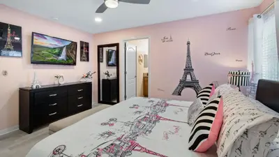 a bedroom with a bed with the eiffel tower mural at Last Minute Disney Getaway! Private Pool, Hot Tub & Games Room. Book Now! #56201 in Kissimmee