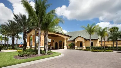 a house with palm trees in the driveway at Last Minute Disney Getaway! Private Pool, Hot Tub & Games Room. Book Now! #56201 in Kissimmee