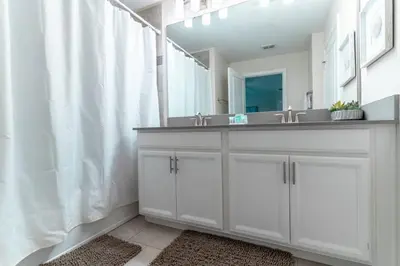 a white bathroom with a sink and a mirror at Storey Lake Resort 1020 - Hosted by Top Villas in Kissimmee