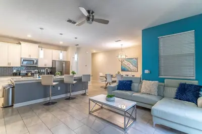 a living room with a couch and a kitchen at Storey Lake Resort 1020 - Hosted by Top Villas in Kissimmee