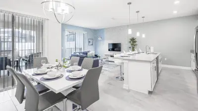 a dining room and living room with a table and chairs at Last Minute Disney Getaway Private Pool Themed Bedrooms. Book Now 93749 in Kissimmee