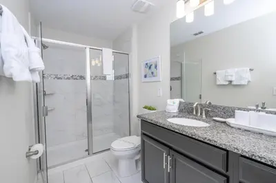 a bathroom with a shower and a toilet and a sink at Last Minute Disney Private Pool Hot Tub Themed Bedrooms. Book Now 93745 in Kissimmee