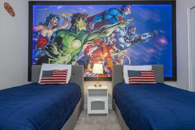 a bedroom with two beds and a mural of avengers at Last Minute Disney Private Pool Hot Tub Themed Bedrooms. Book Now 93745 in Kissimmee