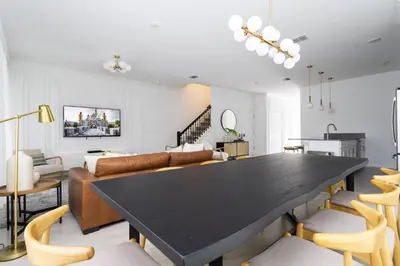 a living room with a large black table and chairs at Last Minute Disney Getaway Private Pool Themed Bedrooms. Book Now 99589 in Kissimmee